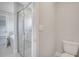 Bathroom featuring glass enclosed shower, toilet, and soaking tub at 555 Viceroy Ct, Kissimmee, FL 34758