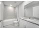 Bright bathroom with a tiled shower and bathtub combination and a white granite vanity at 555 Viceroy Ct, Kissimmee, FL 34758