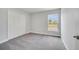 Bright bedroom with carpet flooring, closet, and large window overlooking the backyard at 555 Viceroy Ct, Kissimmee, FL 34758