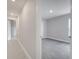Carpeted bedroom with a door leading to a hallway and a bright window overlooking the backyard at 555 Viceroy Ct, Kissimmee, FL 34758