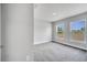 Bright bedroom with two windows offering natural light and plush gray carpeting at 555 Viceroy Ct, Kissimmee, FL 34758