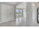Inviting foyer featuring a white front door, tiled flooring, and an open view of the dining area at 555 Viceroy Ct, Kissimmee, FL 34758