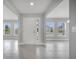 Bright foyer with neutral gray tile flooring, and lots of natural light at 555 Viceroy Ct, Kissimmee, FL 34758