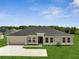 Beautiful single-story home featuring a well-manicured lawn and a neutral color palette at 555 Viceroy Ct, Kissimmee, FL 34758
