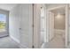 Hallway doorway view leading to carpeted bedroom and bathroom with modern tile and fixtures at 555 Viceroy Ct, Kissimmee, FL 34758