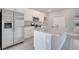 Kitchen features stainless steel refrigerator and island with granite countertop and stainless sink and faucet at 555 Viceroy Ct, Kissimmee, FL 34758