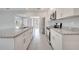 Kitchen features stainless steel appliances and granite countertops with a view into the living space at 555 Viceroy Ct, Kissimmee, FL 34758