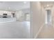 Open-concept living room leading to kitchen with gray tile floors and sliding glass doors to the backyard at 555 Viceroy Ct, Kissimmee, FL 34758