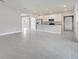 Spacious living room with modern gray tile floors, kitchen with breakfast bar, and stainless steel appliances at 555 Viceroy Ct, Kissimmee, FL 34758