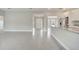 Open-concept space showcasing an entryway, kitchen with island, and light ceramic tile flooring at 555 Viceroy Ct, Kissimmee, FL 34758