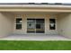 Covered patio with sliding glass doors and view of backyard and surrounding homes at 555 Viceroy Ct, Kissimmee, FL 34758
