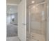 Bathroom with a new glass-enclosed shower and gray tiled walls, plus a door to the bedroom at 557 Viceroy Ct, Kissimmee, FL 34758
