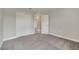 Bedroom with carpet, closet, and a door, featuring neutral walls and white trim at 557 Viceroy Ct, Kissimmee, FL 34758