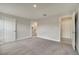 Spacious bedroom with carpet flooring and several entryways offering access to other rooms at 557 Viceroy Ct, Kissimmee, FL 34758