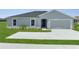 Charming single-story home with a well-manicured lawn and a two-car garage at 557 Viceroy Ct, Kissimmee, FL 34758