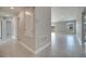 Hallway with tile flooring leading to additional rooms and a glimpse of the home's interior at 557 Viceroy Ct, Kissimmee, FL 34758