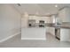 Bright kitchen features granite countertops, white cabinetry, stainless steel appliances, and an island at 557 Viceroy Ct, Kissimmee, FL 34758