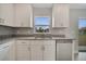 Bright kitchen features granite countertops, stainless steel appliances, and white cabinets at 557 Viceroy Ct, Kissimmee, FL 34758