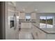 Bright kitchen features granite countertops, stainless steel appliances, and white cabinets at 557 Viceroy Ct, Kissimmee, FL 34758