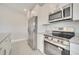 Bright kitchen features granite countertops, stainless steel appliances, and white cabinets at 557 Viceroy Ct, Kissimmee, FL 34758