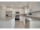 Bright kitchen features granite countertops, stainless steel appliances, and white cabinets at 557 Viceroy Ct, Kissimmee, FL 34758