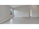 Neutral living room showcasing modern tile flooring and a high vaulted ceiling at 557 Viceroy Ct, Kissimmee, FL 34758
