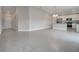 Spacious living room with tile flooring, open to a modern kitchen with stainless appliances at 557 Viceroy Ct, Kissimmee, FL 34758