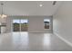 Bright, open living area featuring neutral walls, modern tile floors, and sliding glass doors at 557 Viceroy Ct, Kissimmee, FL 34758