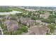 Aerial view showcases the apartment complex with lush landscaping, and beautiful views of the lake at 6548 Swissco Dr # 61, Orlando, FL 32822