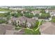 Aerial view of the condominium community with mature trees and landscaping at 6548 Swissco Dr # 61, Orlando, FL 32822