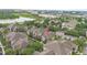 Aerial view showcases the apartment complex with lush landscaping, and beautiful views of the lake at 6548 Swissco Dr # 61, Orlando, FL 32822