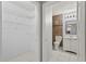 Bathroom with tile floor, white vanity, mirror, and adjacent walk-in closet with wire shelving at 6548 Swissco Dr # 61, Orlando, FL 32822