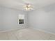 Bright bedroom with ceramic tile flooring, ceiling fan, and natural light at 6548 Swissco Dr # 61, Orlando, FL 32822