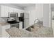 A bright kitchen features granite counters and stainless steel appliances at 6548 Swissco Dr # 61, Orlando, FL 32822