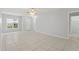 Spacious living area with ceramic tile, large window, and a neutral color scheme at 6548 Swissco Dr # 61, Orlando, FL 32822