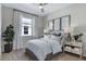 Comfortable bedroom featuring a ceiling fan, neutral walls, carpet, and a large window at 713 Lake Dell Ave, Dundee, FL 33838
