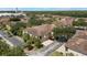 Aerial view featuring the building's exterior, lush trees and on-site parking at 7521 Pellham Way, Kissimmee, FL 34747