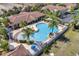 Aerial view of the community pool, clubhouse, with lounge chairs and lush landscape at 7521 Pellham Way, Kissimmee, FL 34747