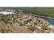 Scenic aerial view of the building complex surrounded by lush trees, a serene lake and a community pool at 7521 Pellham Way, Kissimmee, FL 34747
