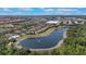 Scenic aerial view of a lakeside community featuring lush landscaping and resort-style amenities at 7521 Pellham Way, Kissimmee, FL 34747
