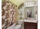 Bathroom featuring a bathtub, shower, toilet, sink, and decorative lizard at 7521 Pellham Way, Kissimmee, FL 34747