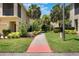 Street view of a charming property showcasing well-kept lawns and beautiful shrubs at 7521 Pellham Way, Kissimmee, FL 34747