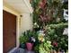 Charming front entryway featuring a wood door, decorative plants, and the home's address at 7521 Pellham Way, Kissimmee, FL 34747