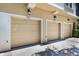Three-car garage with individual doors and lighting, providing ample parking and storage at 7521 Pellham Way, Kissimmee, FL 34747