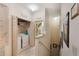 Hallway featuring a laundry room with a washer and dryer as well as a water closet at 7521 Pellham Way, Kissimmee, FL 34747