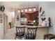 Well-equipped kitchen with dark wood cabinets, stainless steel appliances, and a breakfast bar at 7521 Pellham Way, Kissimmee, FL 34747