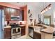 A functional kitchen features wood cabinetry, modern appliances, and a breakfast bar at 7521 Pellham Way, Kissimmee, FL 34747