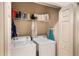 Washer and dryer in a laundry room with shelving for storage at 7521 Pellham Way, Kissimmee, FL 34747