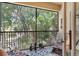 Relaxing screened porch with comfortable seating and serene views of lush tropical landscaping at 7521 Pellham Way, Kissimmee, FL 34747