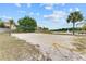 Sandy volleyball court with net and seating area in a community with lake views at 7521 Pellham Way, Kissimmee, FL 34747